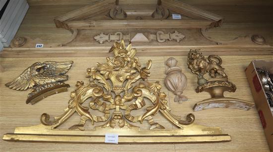 A 19th century carved giltwood door pediment, another giltwood carving of a lion rampant and an architectural style pediment (3)